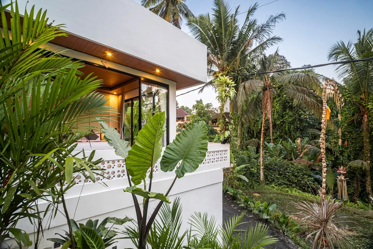 Open outlook over the palm canopy from the upper level at Aung Villa, Ubud